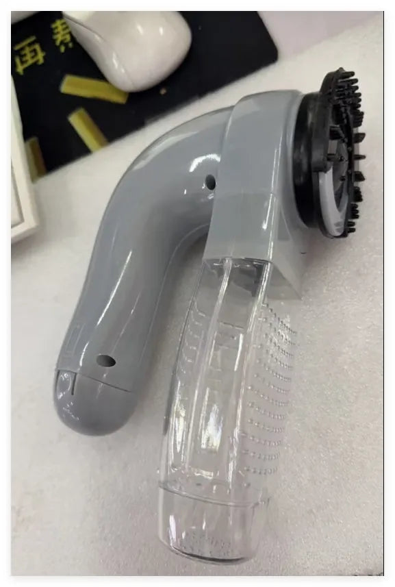 Grey portable pet hair vacuum cleaner with soft rubber head for grooming dogs and cats.