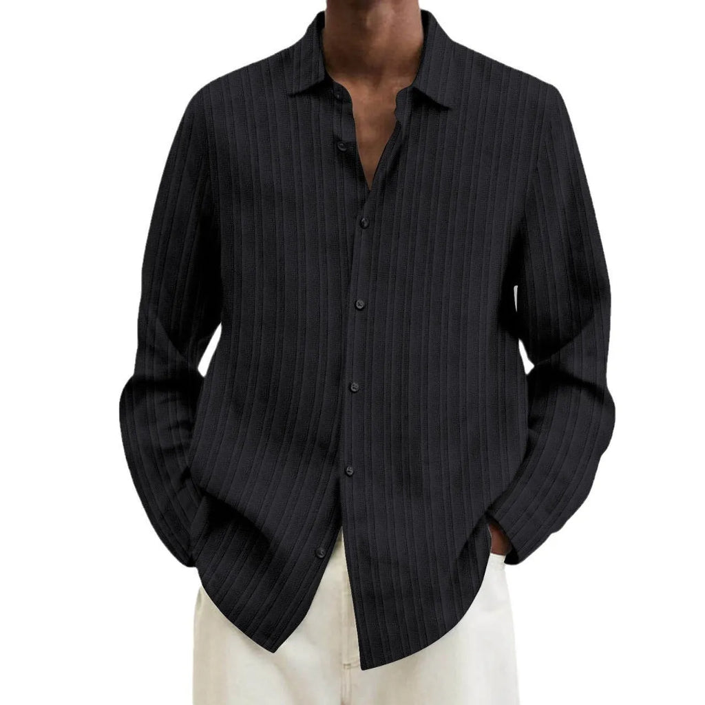 A man's loose-fit striped cardigan shirt with long sleeves in a British style design.