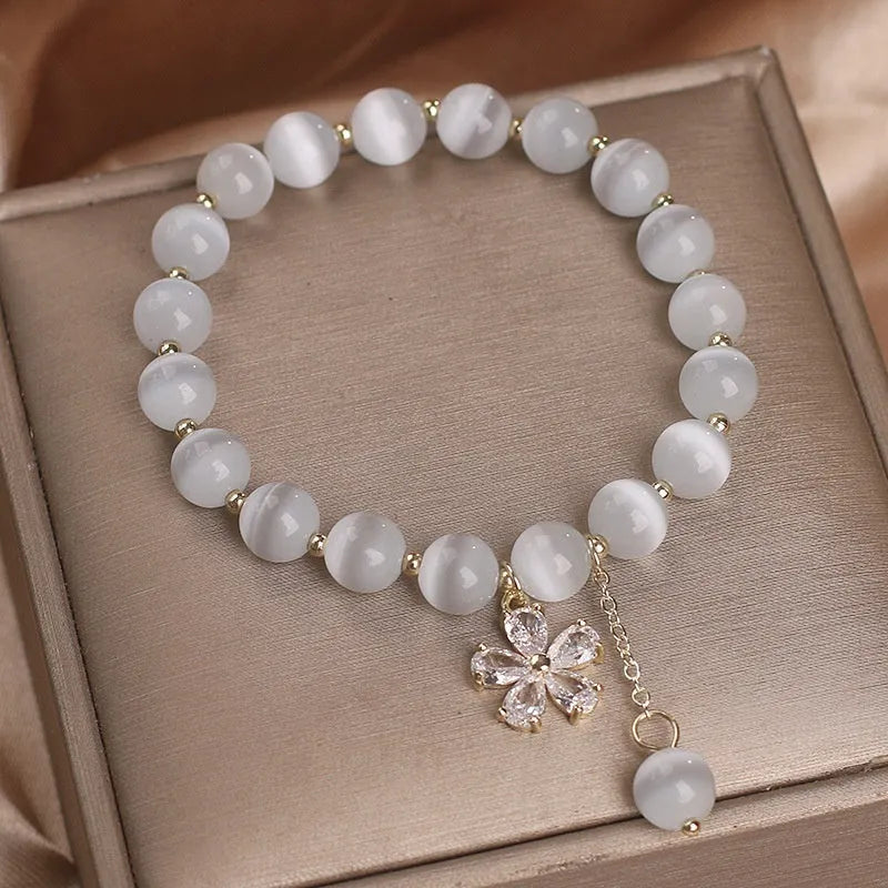 White cat's eye crystal bracelet with floral tassel and morganite safety buckle