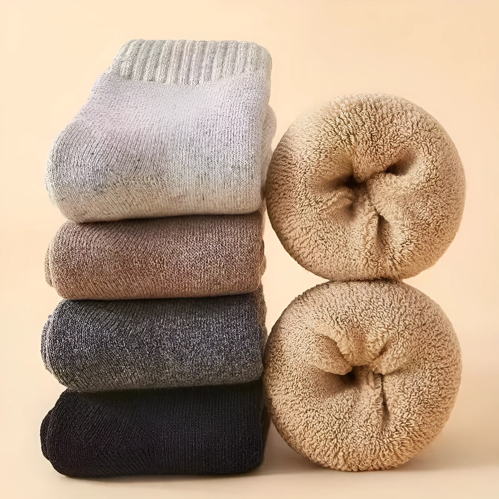 Pair of thick, solid-colour men's winter socks showcasing the cushioned footbed and mid-calf height.