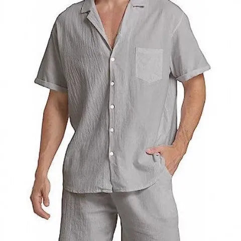 Man wearing a grey flax linen short-sleeved top and matching shorts from the summer sports suit set.