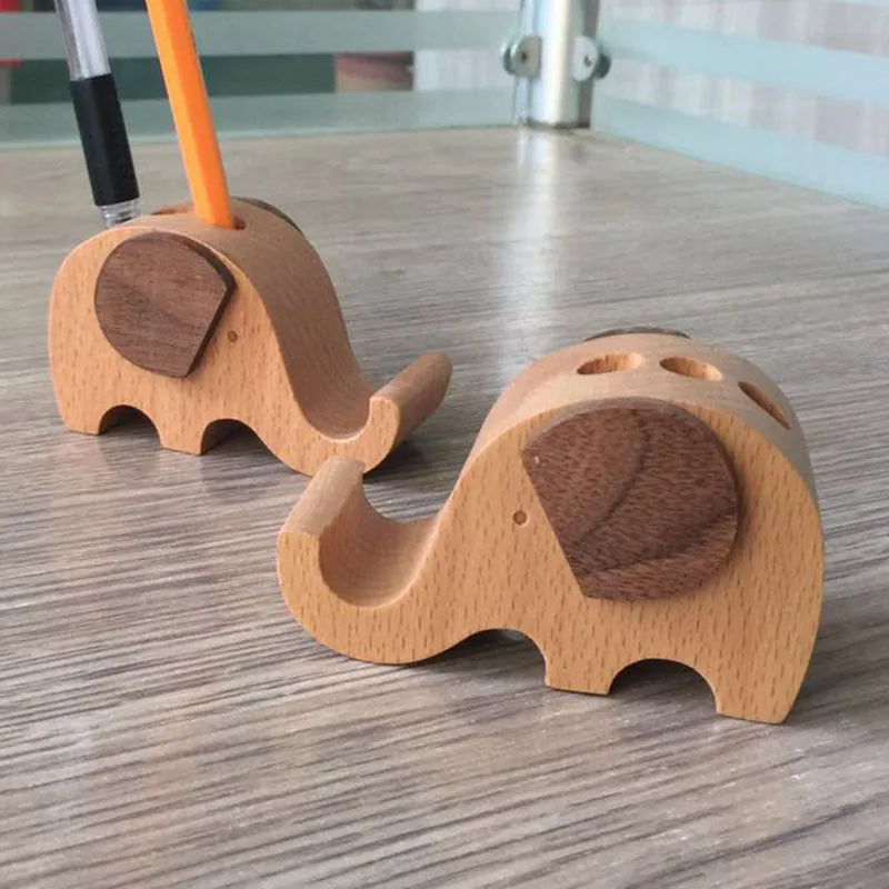 Solid beech wood phone holder with resin puppy decoration and a pound coin in the integrated slot.