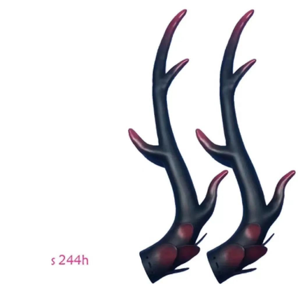 A pair of black resin dragon horn decorations for motorcycle helmets, showing curved shape and textured surface.