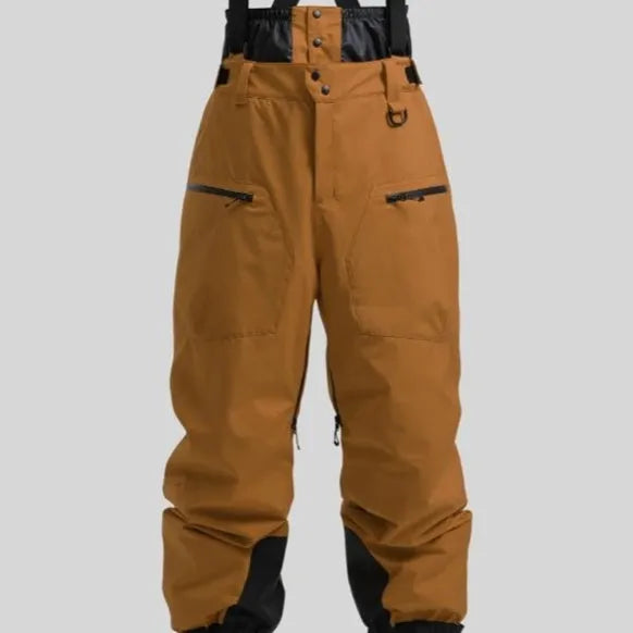 Man wearing black waterproof ski pants with adjustable ankle straps.