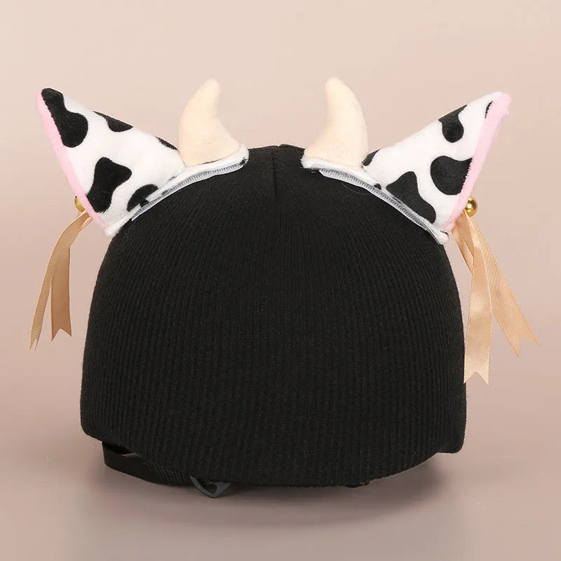 Colourful plush cartoon hat decoration sitting on top of a ski helmet