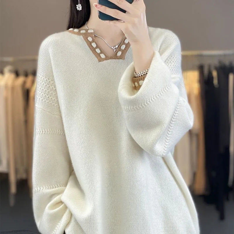 Women's white V-neck long sleeve viscose pullover sweater on a hanger.
