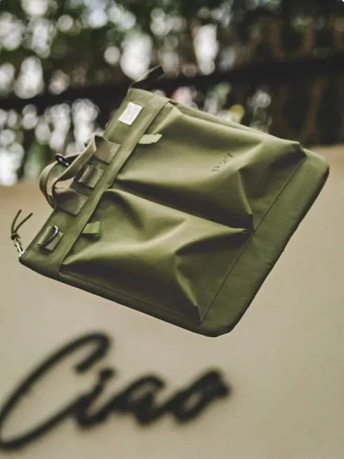 Retro canvas crossbody messenger bag in military green showing laptop compartment and phone storage