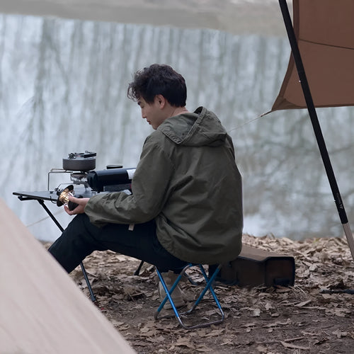 Black folding camping stool with aluminum alloy frame, shown in folded and unfolded positions.