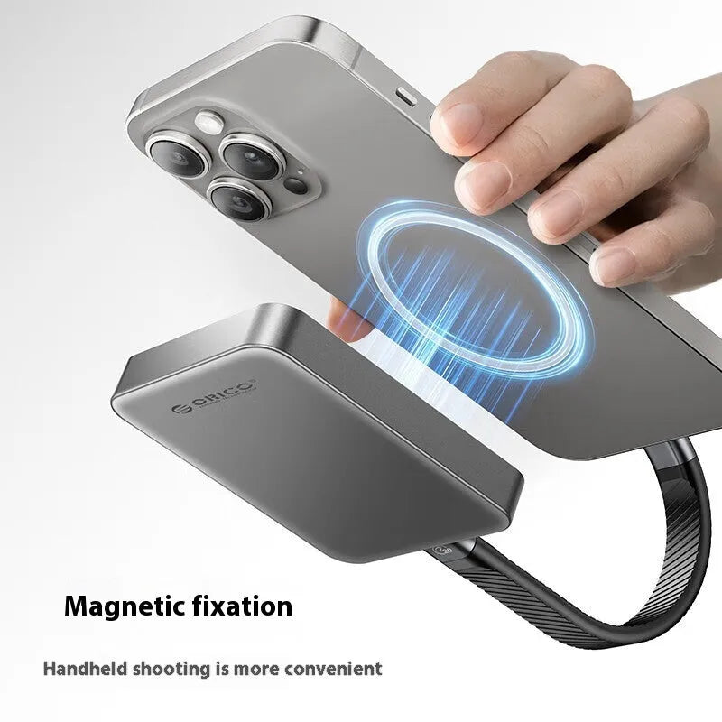 Grey ultra-thin magnetic mobile solid state drive with C to C cable and magnetic suction ring on a table.