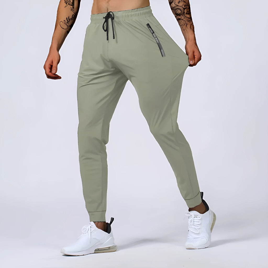 Men's loose mid waist jogging sports pants in black, grey, khaki, or blue, high elasticity nylon blend, sizes L to 7XL