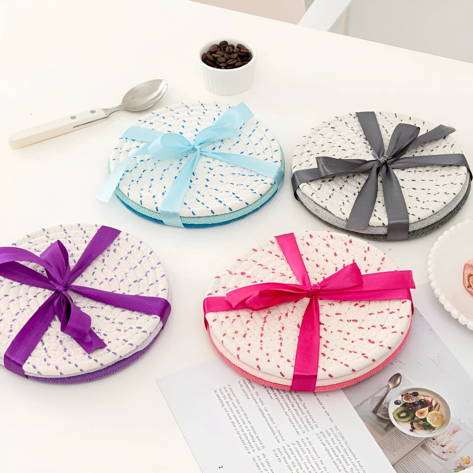 Three round cotton cord coasters in 18cm diameter showing grey, pink, purple and blue colour options