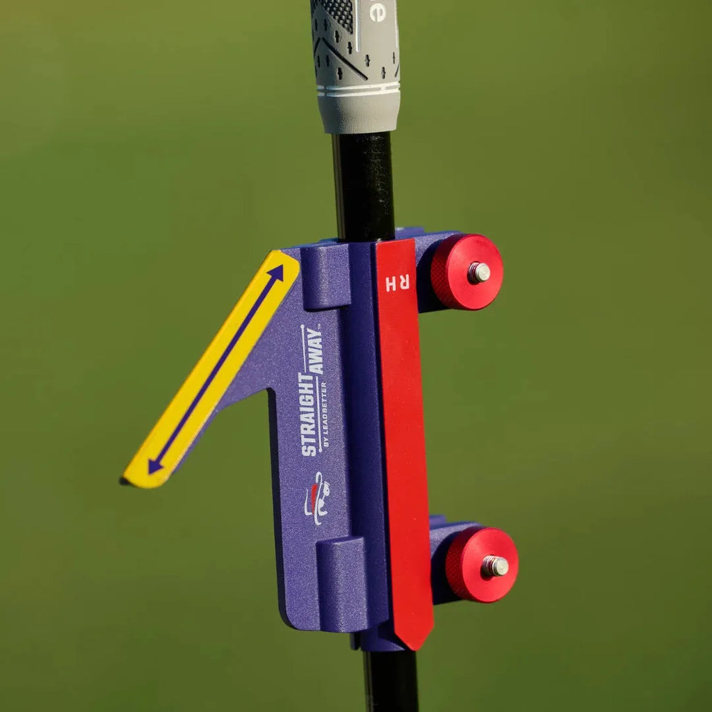 Golf swing plane simulator training aid made of plastic on a practice green.