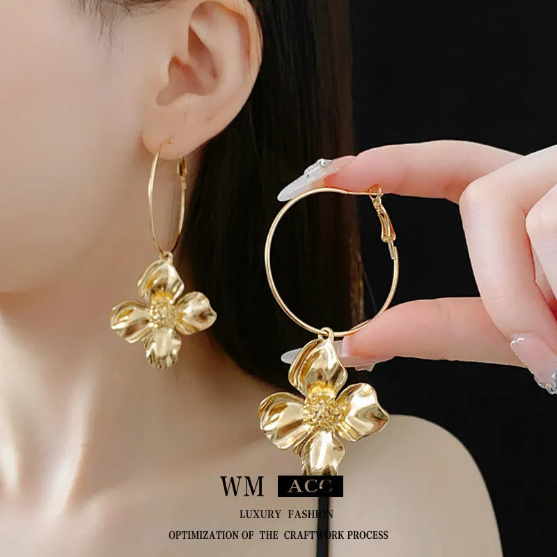 Gold and silver metal earrings with floral geometric design and electroplated finish