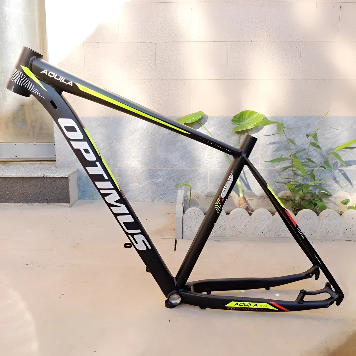 Black green aluminium mountain bike frame showing disc brake mount and inner cable routing ports