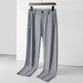 Man wearing black ice silk straight-leg loose casual trousers with an elastic waist.