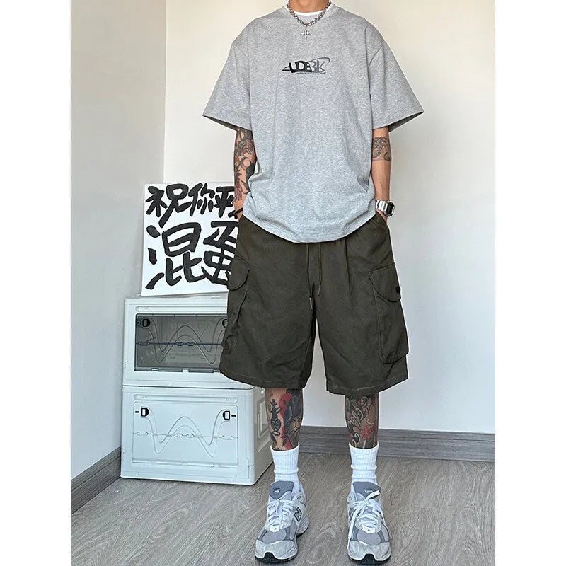 A pair of loose-fitting straight-leg casual shorts in a sports style, made from polyester fabric, shown in one of four colour options.