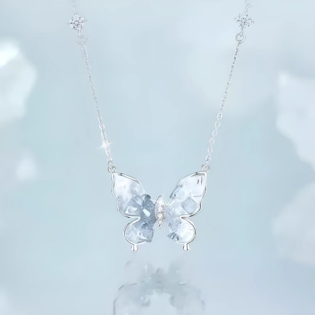 Close-up of a silver butterfly pendant on an adjustable O-ring chain, showing detailed wings and a 41-50 cm length.