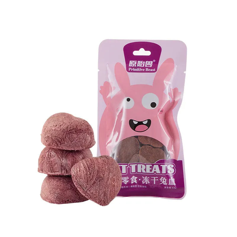 Assorted freeze-dried pet snacks including chicken, salmon and egg yolk flavours in small resealable bags.