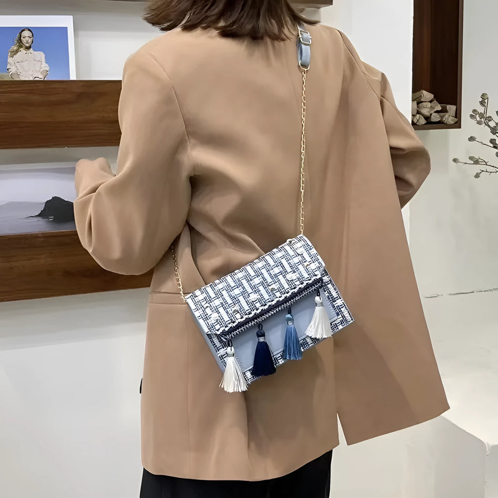 Ethnic-style horizontal square PU bag in beige with polyester lining, medium-hard structure, and flat lay on surface