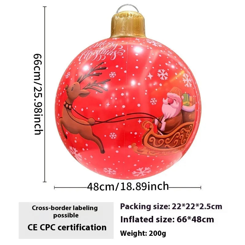 Large red and white inflatable Christmas ball with flashing lights standing in a garden.