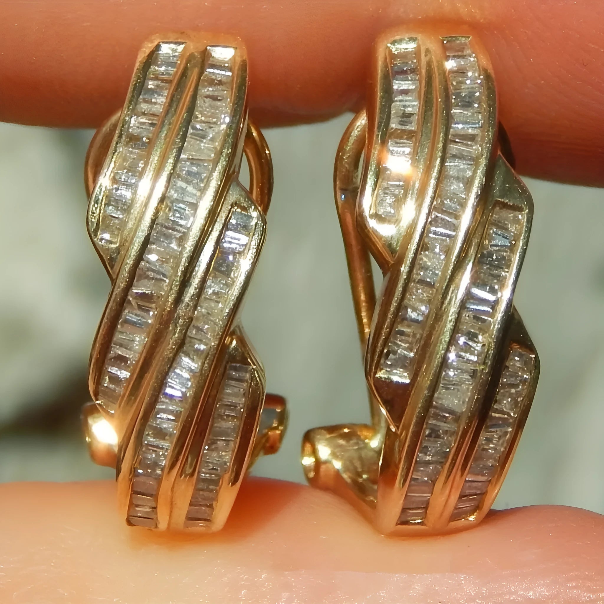 A pair of gold geometric earrings with a round design made from copper.