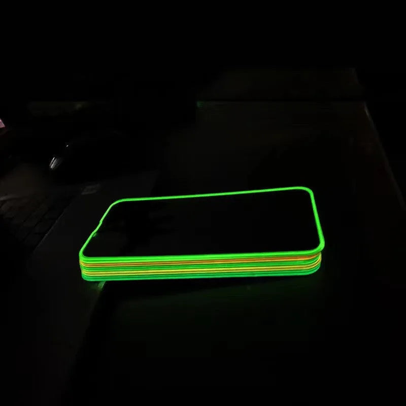 Fluorescent pink tempered glass screen protector applied to an iPhone 13 Pro, glowing softly on a dark background.