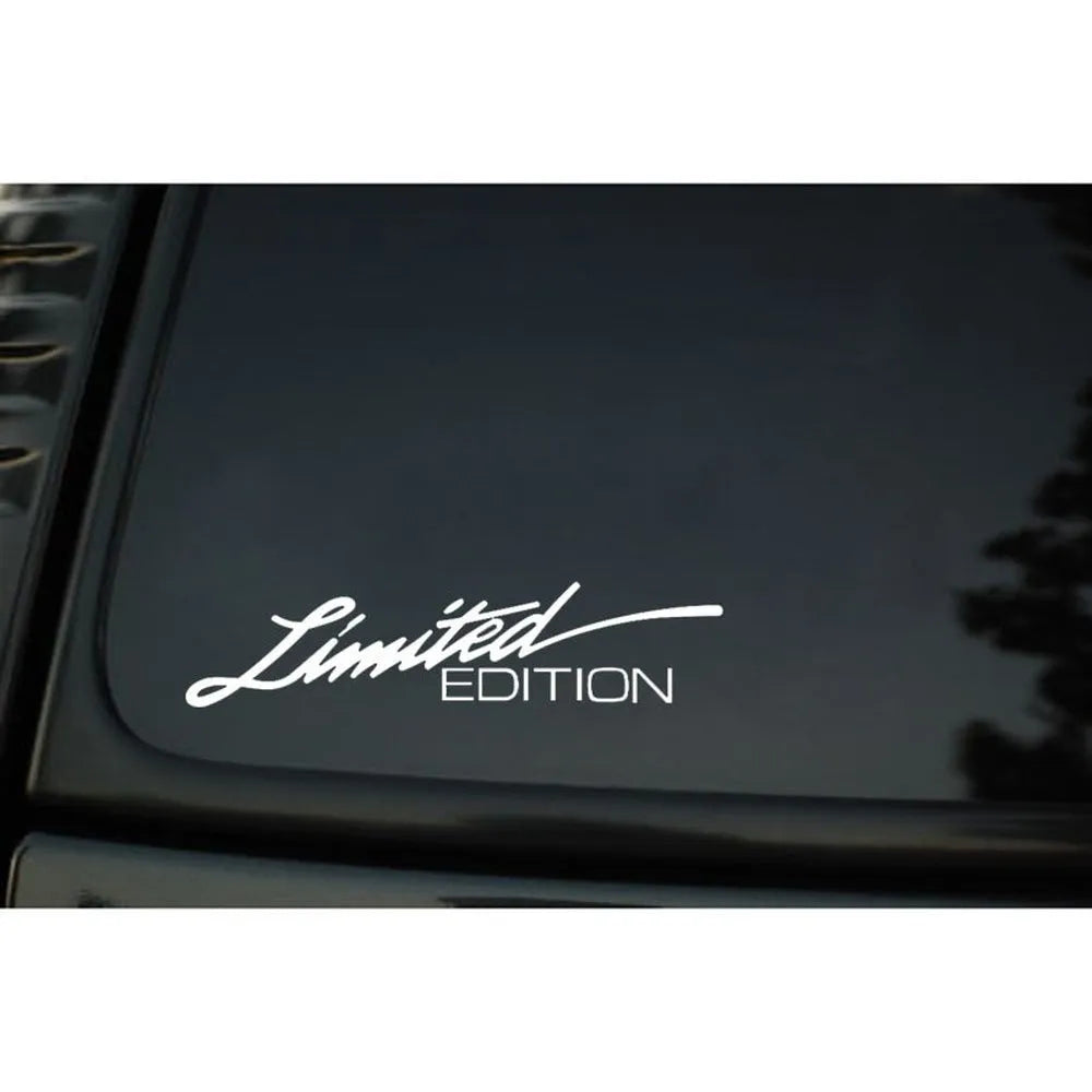 A black, white, and colourful British style reflective plastic bumper sticker, shown at its 16cm by 3.8cm size.