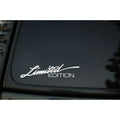 A black, white, and colourful British style reflective plastic bumper sticker, shown at its 16cm by 3.8cm size.