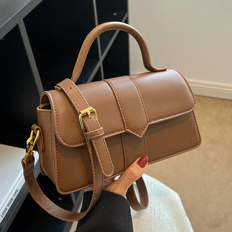 Beige women's horizontal square messenger bag with sandwich pocket and file organiser interior.