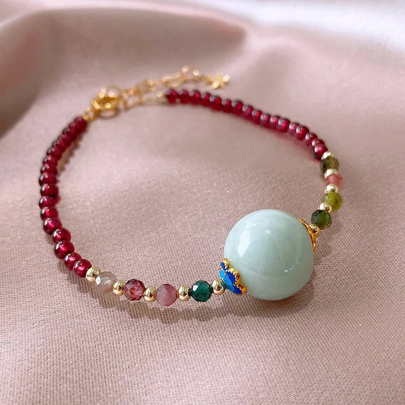 Aquamarine garnet bracelet with drop-shaped tourmaline centrepiece on wrist