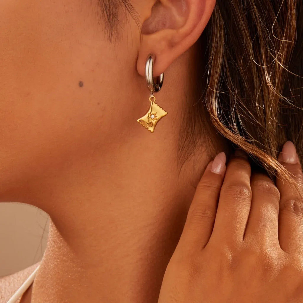 Stainless steel geometric earrings with 18K electroplated finish showing heart and star shapes