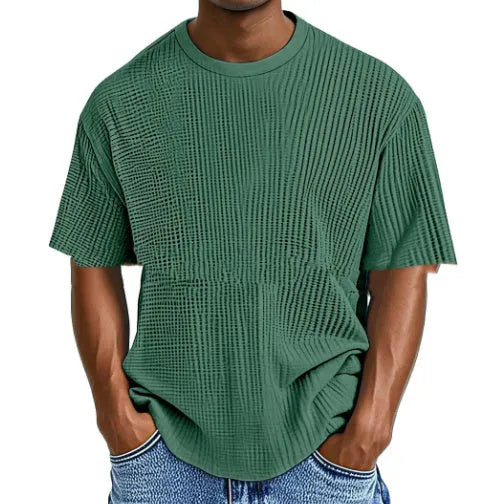 Man wearing a light blue cotton blend waffle knit short sleeve casual T-shirt.