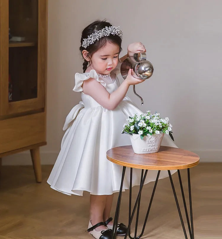 Girls' white satin princess dress with puff sleeves, full-length view, white fabric