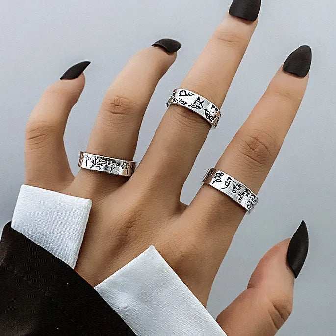 Alloy ring set with butterfly and snake retro geometric designs on display
