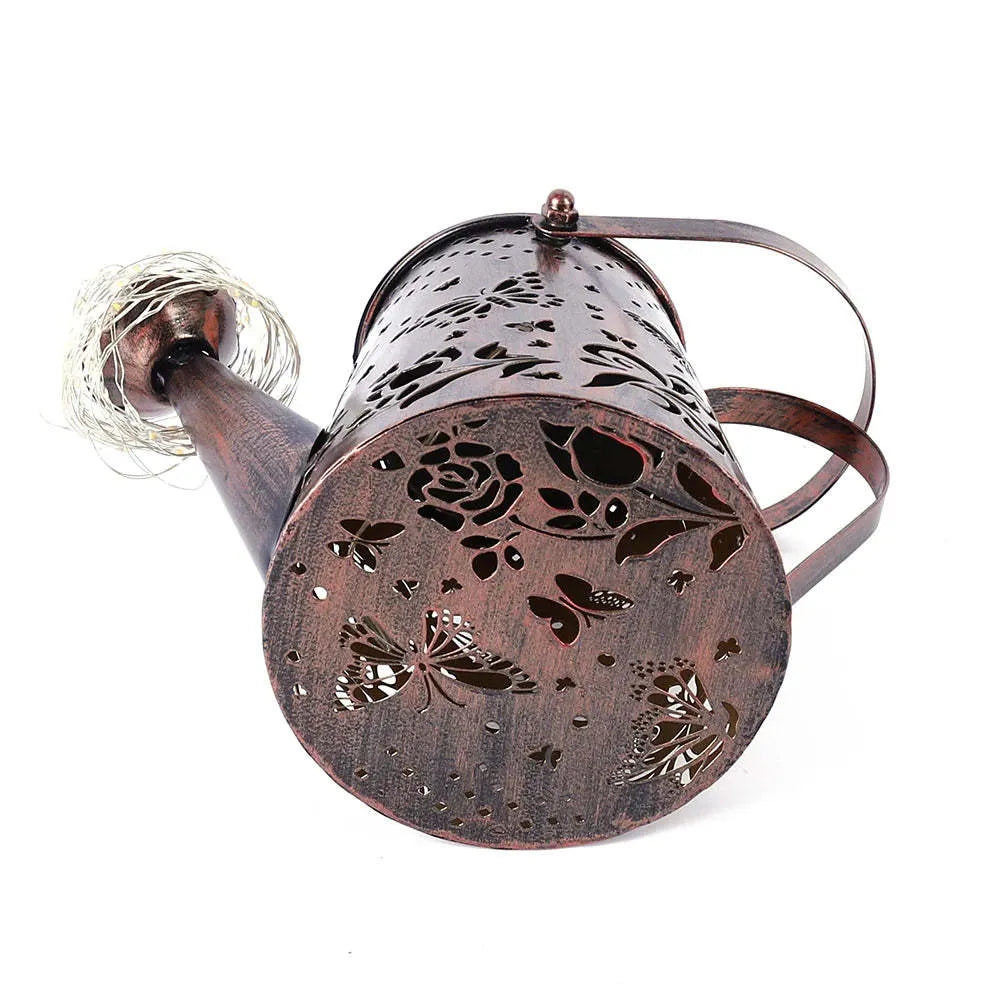 Solar garden lamp with tapered iron butterfly design and warm white LED light.