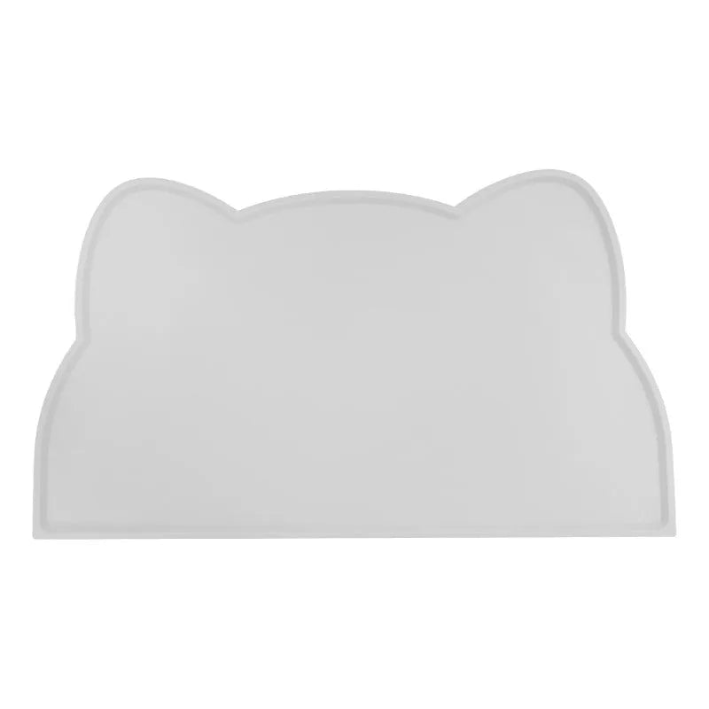 Blue silicone pet feeding mat for dog or cat bowls on a wooden floor.