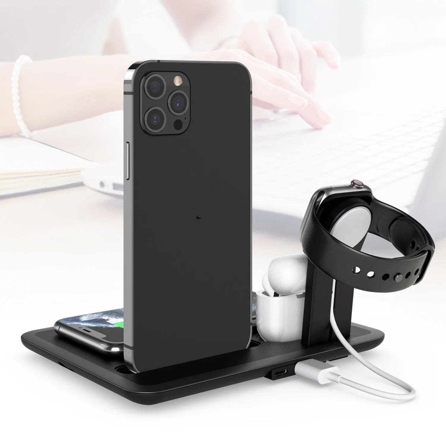 Black and white wireless desktop charger for phone, watch, and headphones.