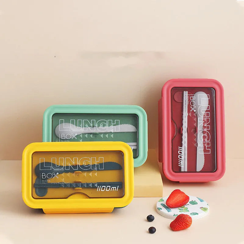 Green four-layer partitioned bento box with Nordic style design on a table.