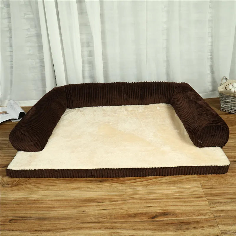 Grey corduroy dog sofa bed with raised sides and a non-slip base on a wooden floor.