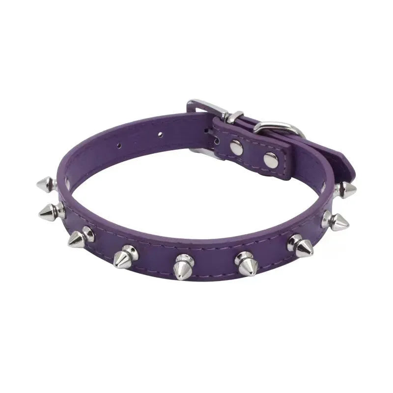 Close-up of a studded black PU leather dog collar with metal spikes and a silver alloy buckle fastener.