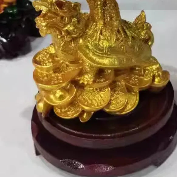 A citrine-coloured resin decorative ornament of a small water turtle and a money tree in Chinese style.