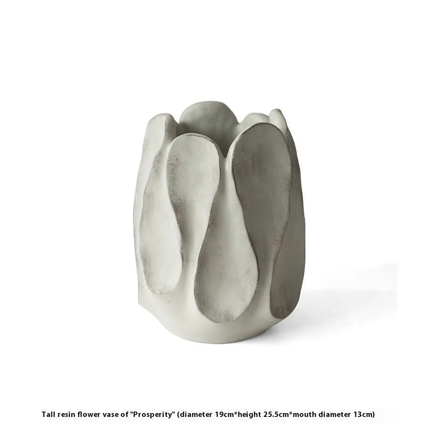 Irregular shaped handcrafted ceramic vase on a wooden surface, showing its artisanal form.
