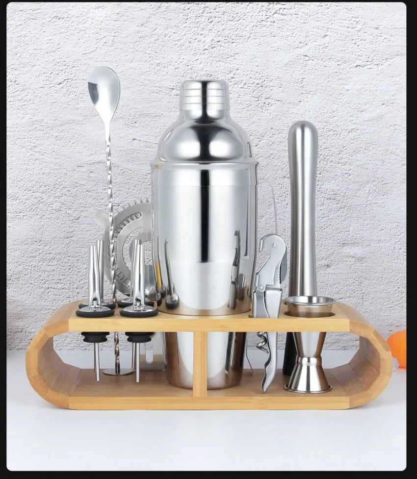 23-piece stainless steel cocktail set with acrylic shakers and bar tools laid out.