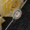 European small gold women's watch with handmade rhinestone inlay on a white background