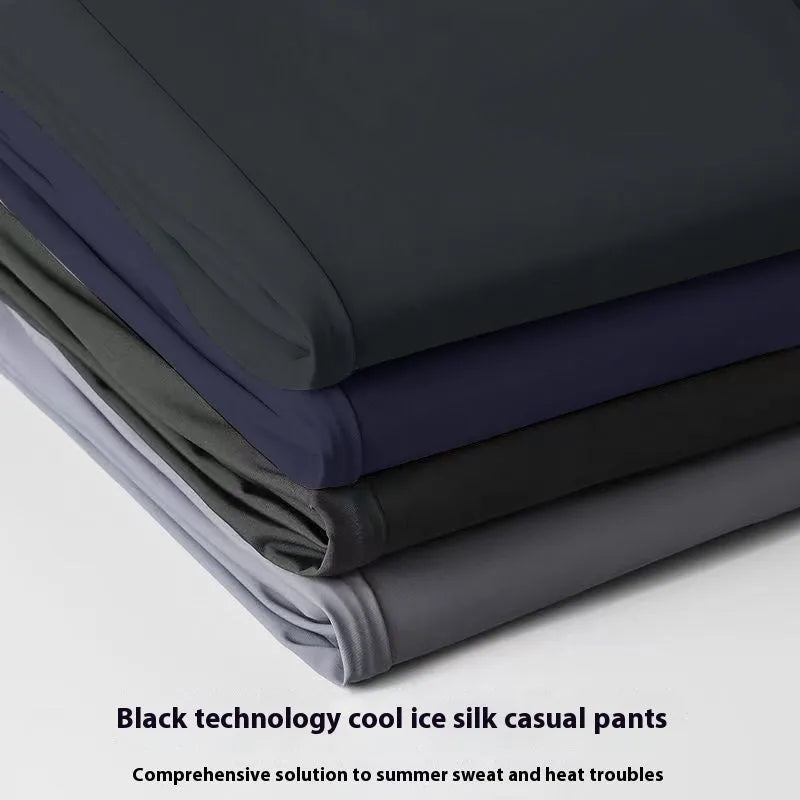 Man wearing black ice silk straight-leg loose casual trousers with an elastic waist.