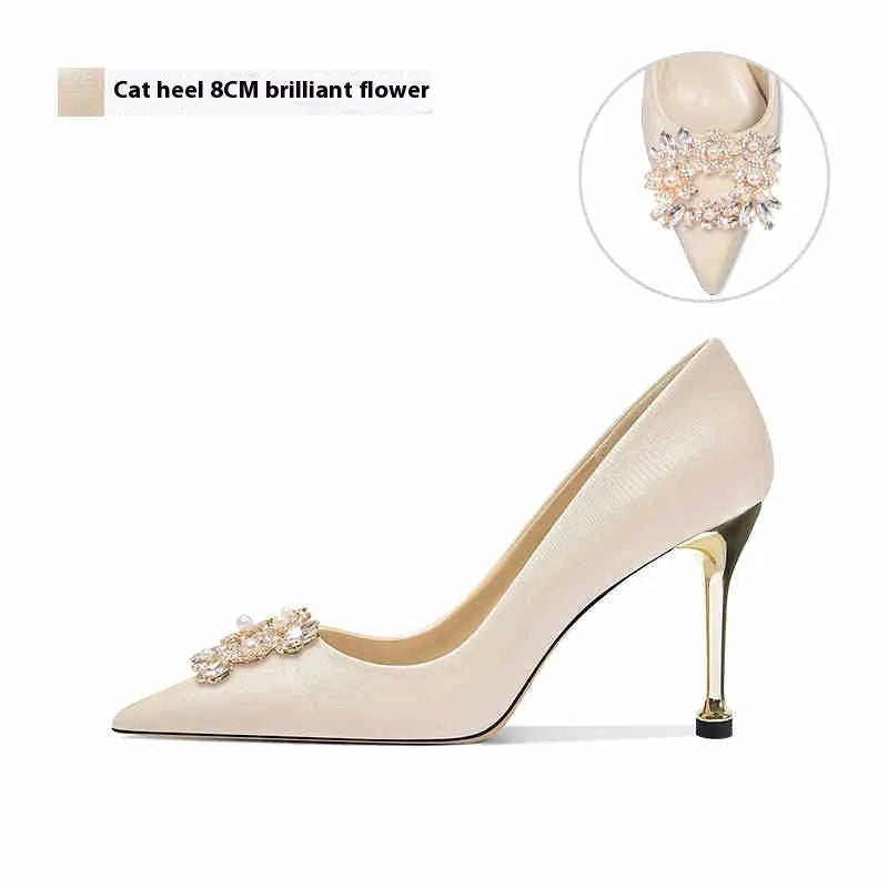 Rhinestone-decorated pointed-toe bridal high heels with a stiletto heel on a white background.