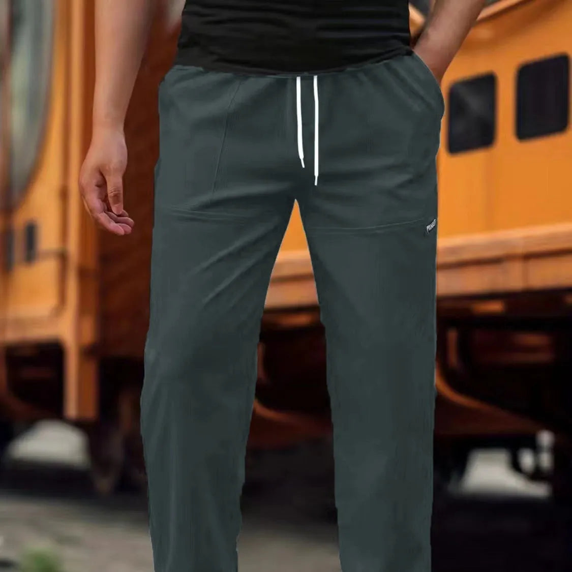 Men's light grey polyester casual trousers for spring and autumn wear.