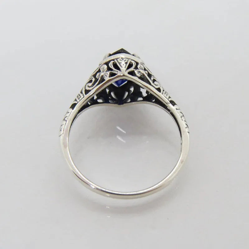 Silver women's geometric hollow alloy ring showing detailed openwork design.