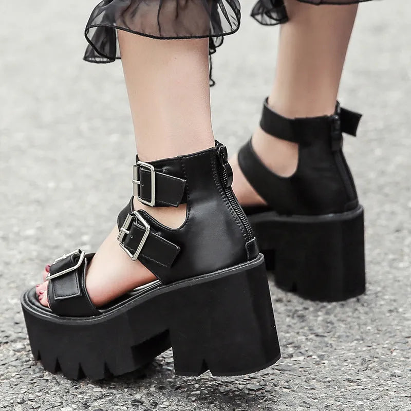 Black women's punk style platform sandals with chunky heel, round toe, buckle straps, and a rear zipper.