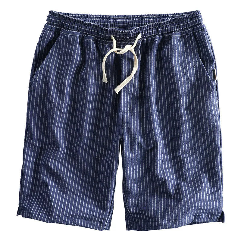 Man wearing black and white striped casual cotton shorts with a loose straight-leg fit.
